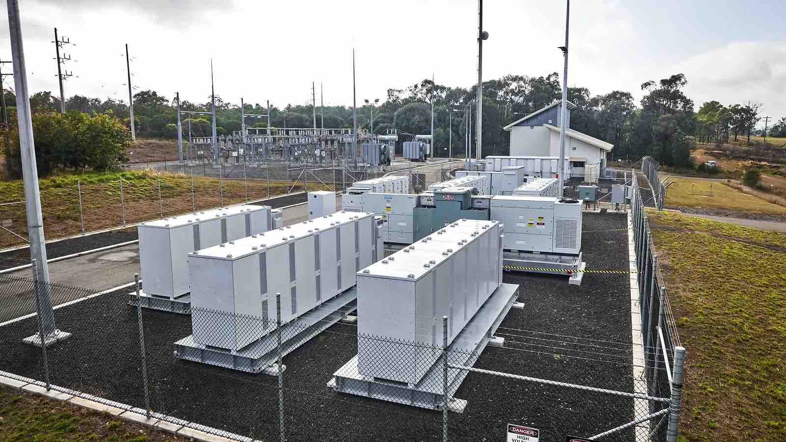 Battery Energy System cabinets and switchgear beside a substation