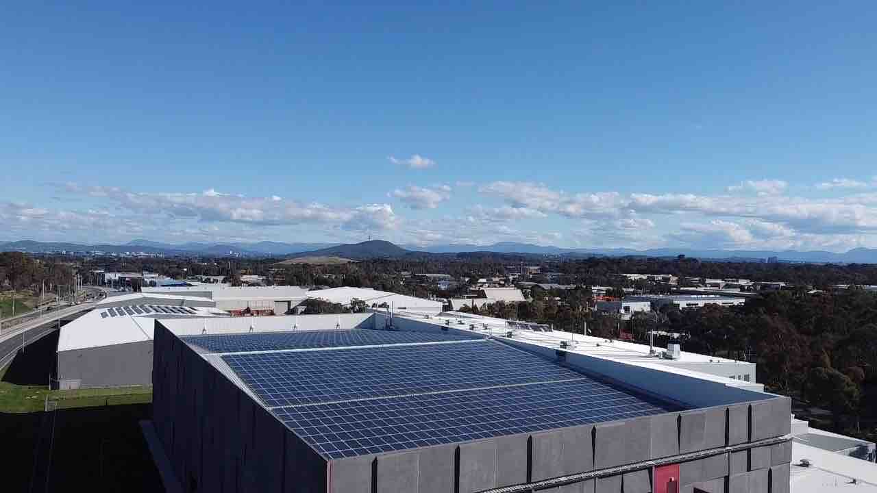 Aerial of Doma hotels and the National Archives rooftop solar arrays in the ACT