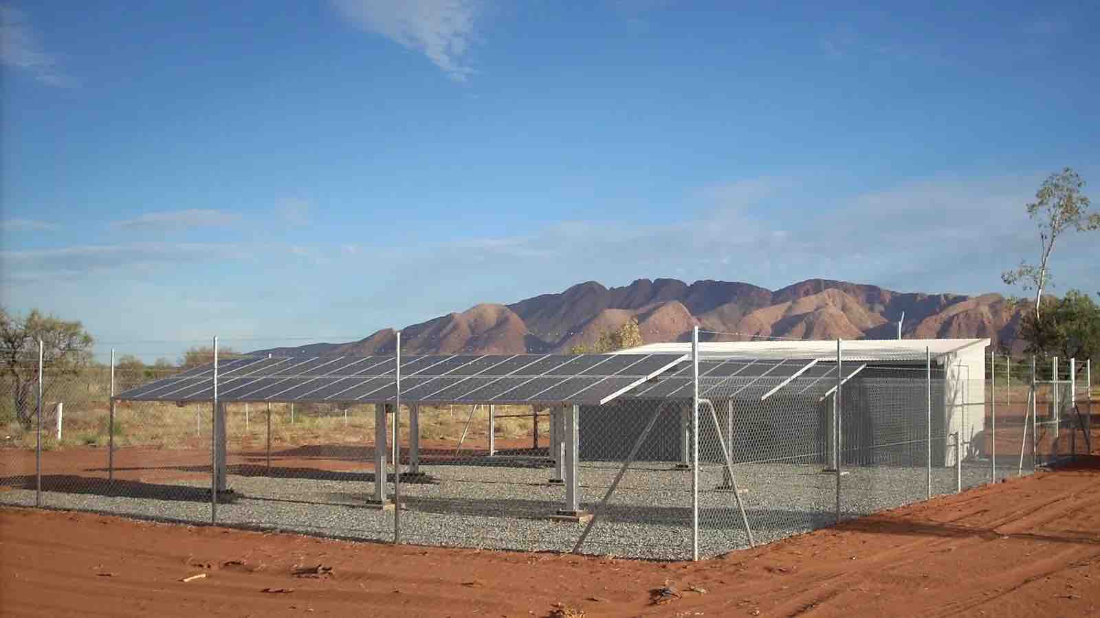 Ground mounted solar array powering a remote homelands community, with the ranges behind it